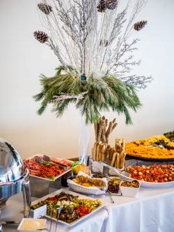 A variety of food displayed prominently on a table at the Conference Center in the Main Ballroom.