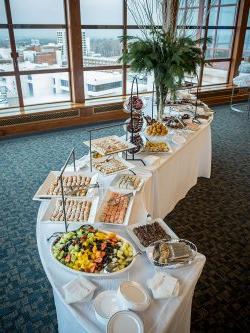 A various amount of food displayed on a table at an event at the Conference Center.