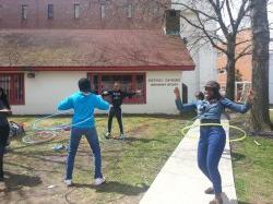 Three students hula hooping outside the Drop In Center