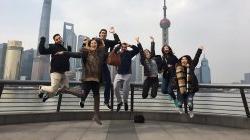 Students jumping in front of Shanghai skyline