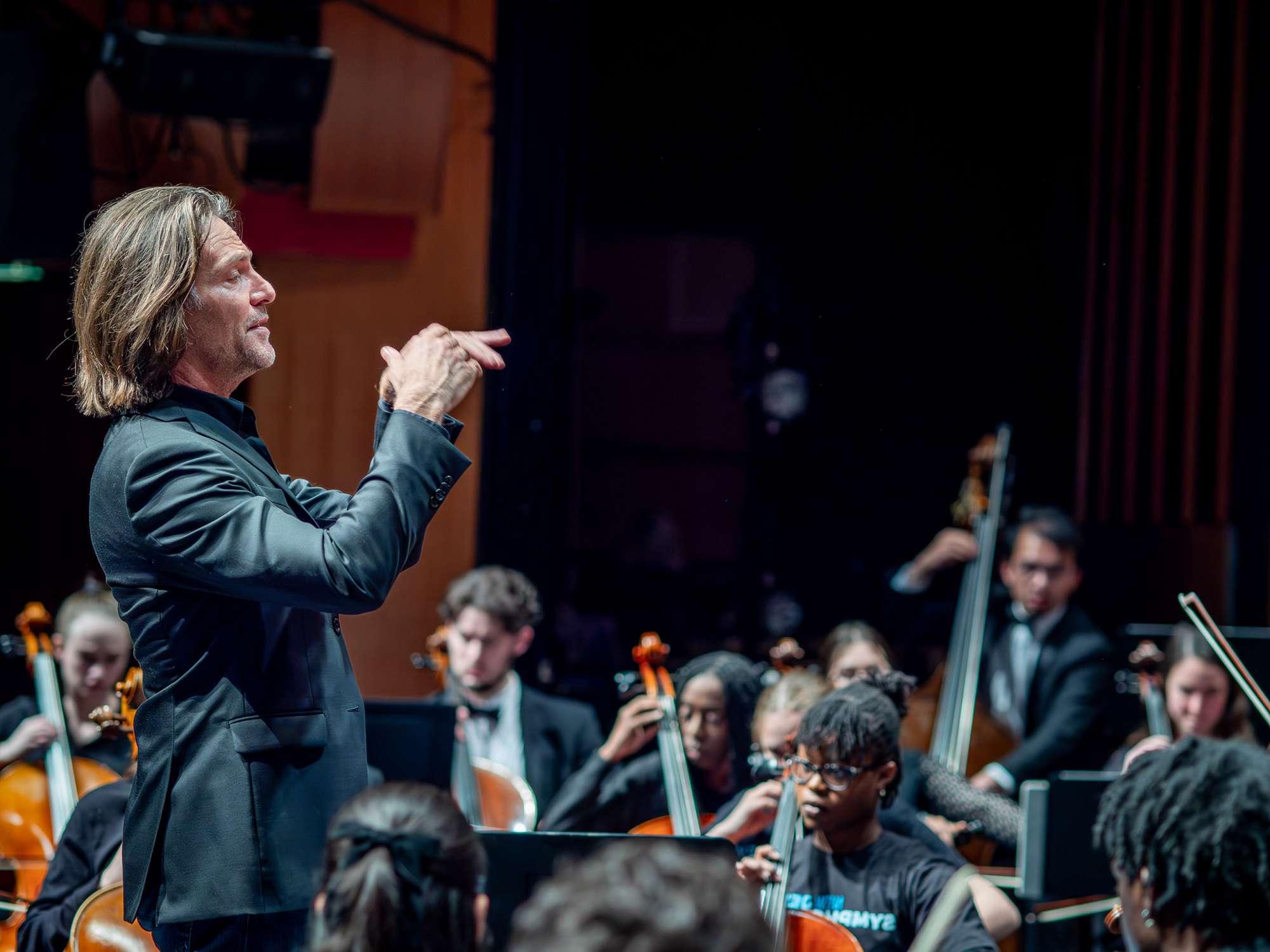 A man conducts an orchestra