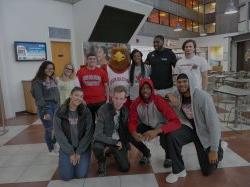 Students hanging out with Rocky the Red Hawk in the Blanton Hall atrium.