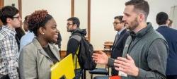Image of a student speakng with a prospective employer at a career fair.